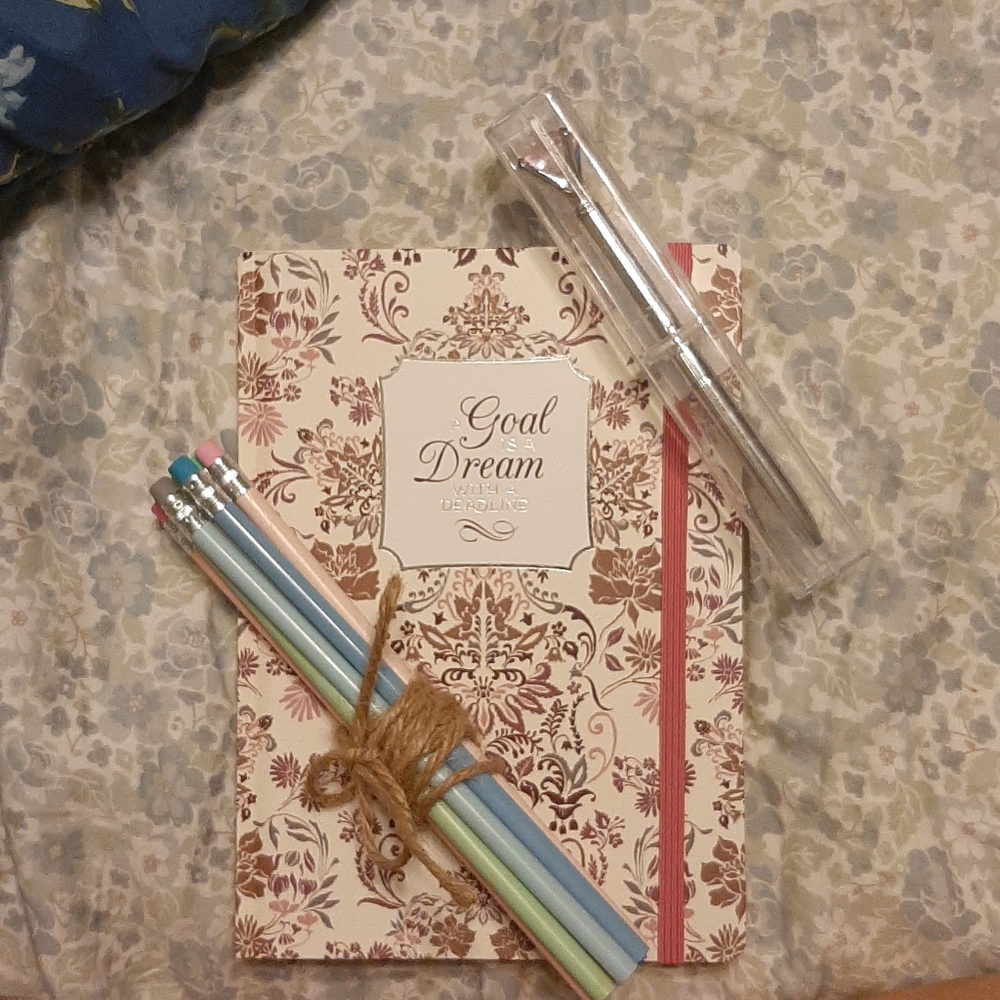 Notebook, pen, and pencils